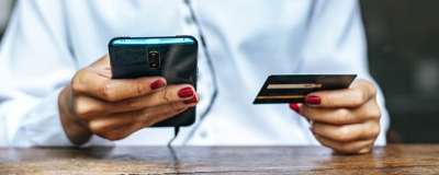 Decorative image - Woman holding mobile and credit card