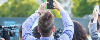 Decorative image - People filming news event