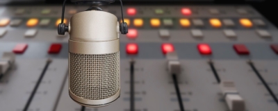 Decorative image - Radio studio microphone and mixing desk