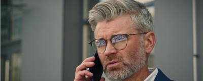 Decorative image - Man on phone outside building