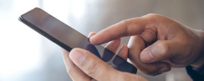 Decorative image - Person scrolling on mobile phone