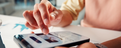 Decorative image - Person scrolling news article on phone
