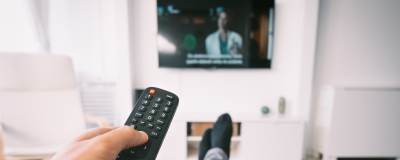 Decorative image - Person watching TV with subtitles