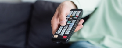 Decorative image - Woman holding TV remote