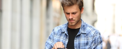 Decorative image - Concerned young man scrolling on phone