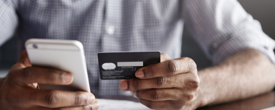 Decorative image - Man holding credit card and mobile phone