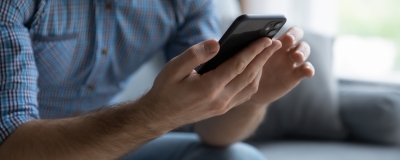 Decorative image - Man scrolling on mobile phone