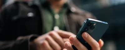 Decorative image - Man navigating screen on mobile phone