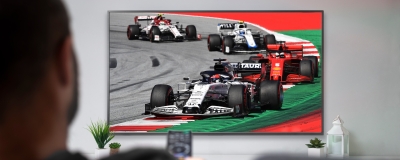 Decorative image - Man watching formula one racing on TV