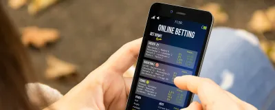 Decorative image - Person doing online betting on phone